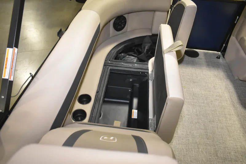 Slide: The Image of 2026 Premier 220 Sunscape RF - CL boat interior with open storage compartment and cup holders. - 15