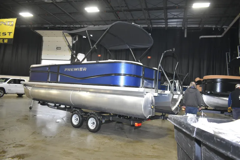 Slide: The Image of 2026 Premier 220 Sunscape RF - CL pontoon boat displayed indoors on a trailer. - 3