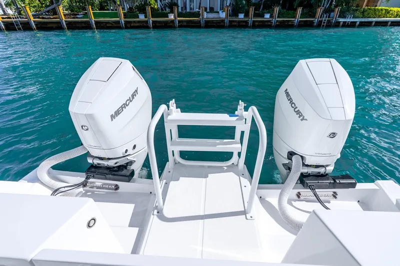 Slide: The Image of 2026 Hammer Yachts 35HH with dual Mercury outboard engines on clear blue water. - 28