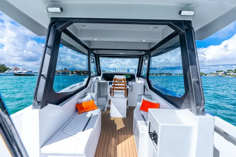 Slide: The Image of Luxurious 2026 Hammer Yachts 35HH interior with ocean view, featuring modern seating and vibrant cushions. - 36