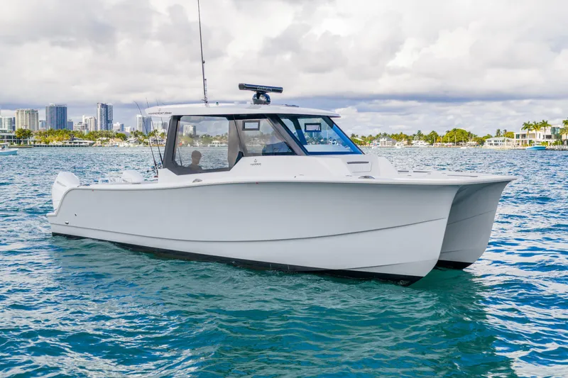 Slide: The Image of 2026 Hammer Yachts 35HH catamaran on water, city skyline in background. - 8