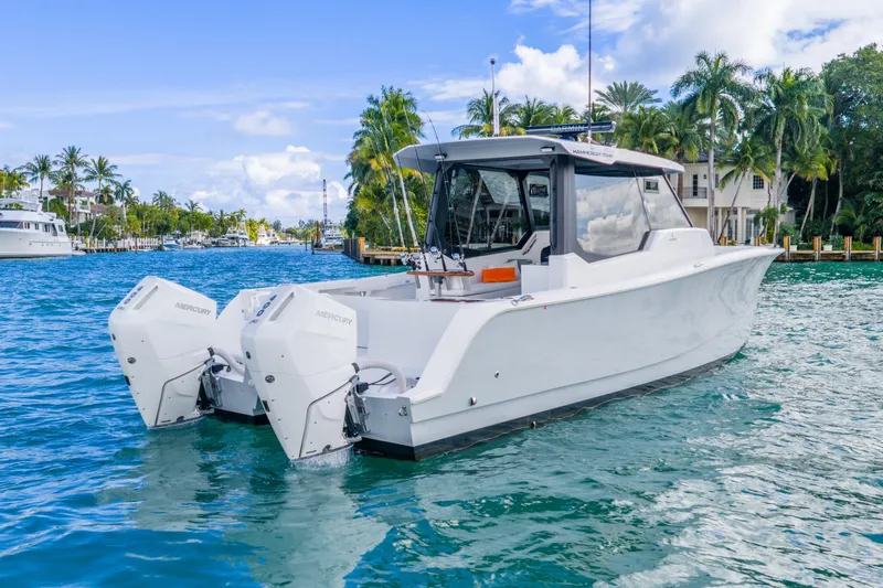 Slide: The Image of 2026 Hammer Yachts 35HH boat on tropical water with twin Mercury engines. - 9