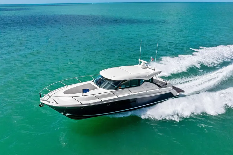 Slide: The Image of 2018 Tiara Yachts C44 Coupe cruising on turquoise waters. - 13