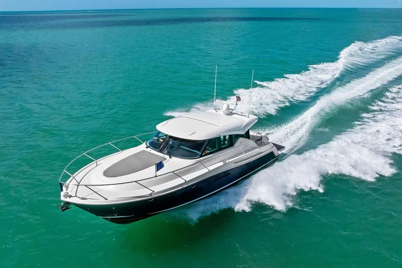 Slide: The Image of 2018 Tiara Yachts C44 Coupe cruising on turquoise ocean waters. - 14