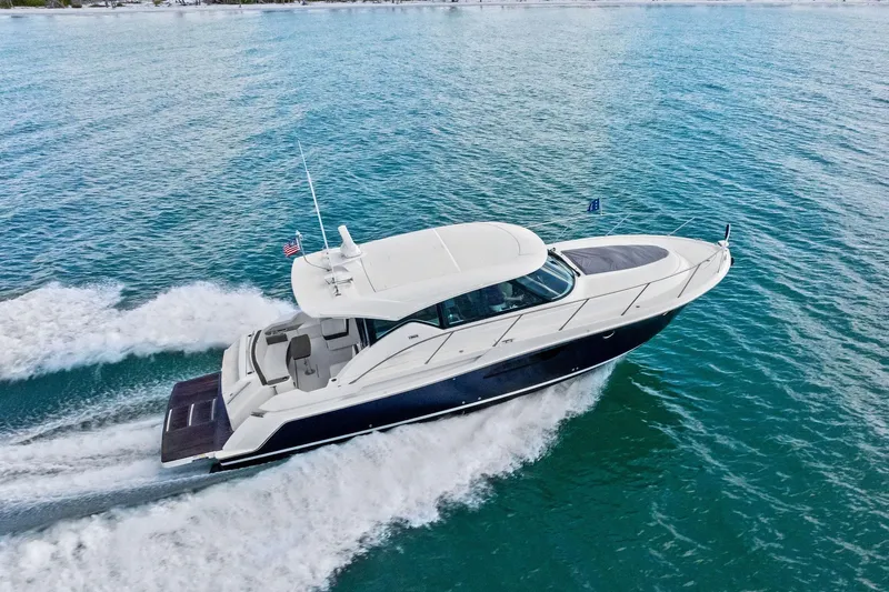 Slide: The Image of 2018 Tiara Yachts C44 Coupe cruising on open water, showcasing sleek design and performance. - 16