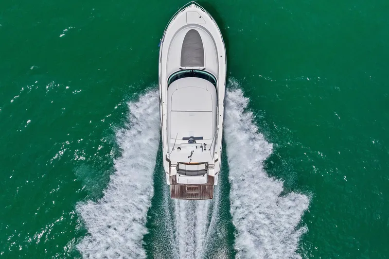 Slide: The Image of Aerial view of 2018 Tiara Yachts C44 Coupe cruising on turquoise water. - 20