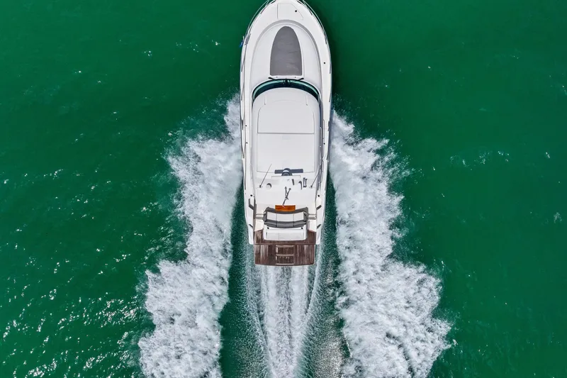 Slide: The Image of Aerial view of 2018 Tiara Yachts C44 Coupe cruising on turquoise water. - 21