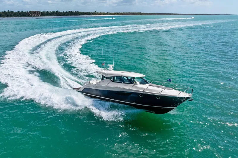 Slide: The Image of 2018 Tiara Yachts C44 Coupe cruising on turquoise ocean waters. - 22