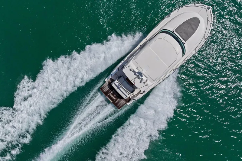 Slide: The Image of Aerial view of 2018 Tiara Yachts C44 Coupe cruising on turquoise water. - 25