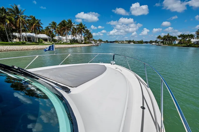Slide: The Image of 2018 Tiara Yachts C44 Coupe cruising on a scenic, tropical waterway. - 28