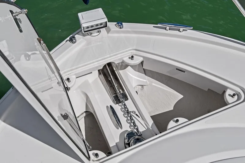 Slide: The Image of Anchor compartment of 2018 Tiara Yachts C44 Coupe, featuring a sleek design and chain mechanism. - 29