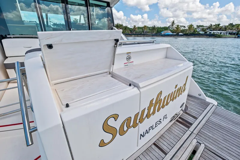 Slide: The Image of 2018 Tiara Yachts C44 Coupe, "Southwind" docked in Naples, FL, with open storage compartments. - 33