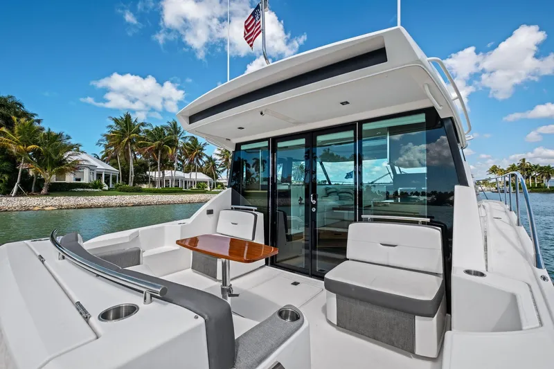 Slide: The Image of 2018 Tiara Yachts C44 Coupe on water, featuring sleek design and luxurious seating. - 36
