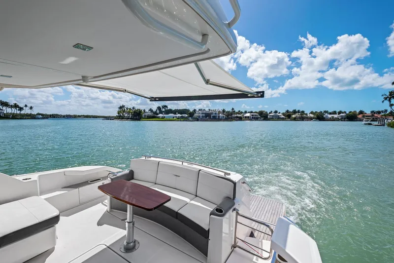 Slide: The Image of 2018 Tiara Yachts C44 Coupe, luxurious deck view, calm waters, sunny day. - 37