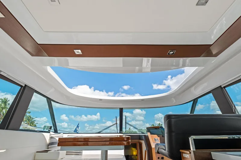Slide: The Image of Interior view of 2018 Tiara Yachts C44 Coupe with open sunroof and blue sky. - 40
