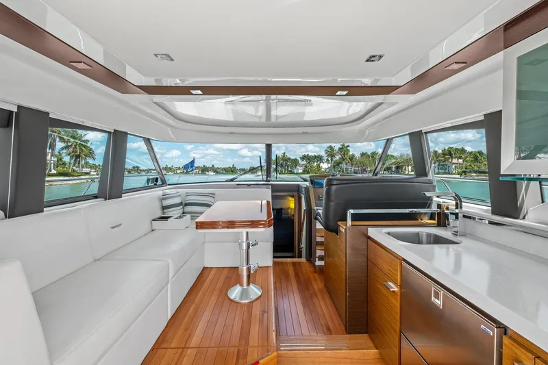 Slide: The Image of Luxurious interior of 2018 Tiara Yachts C44 Coupe with modern seating and kitchen area. - 42