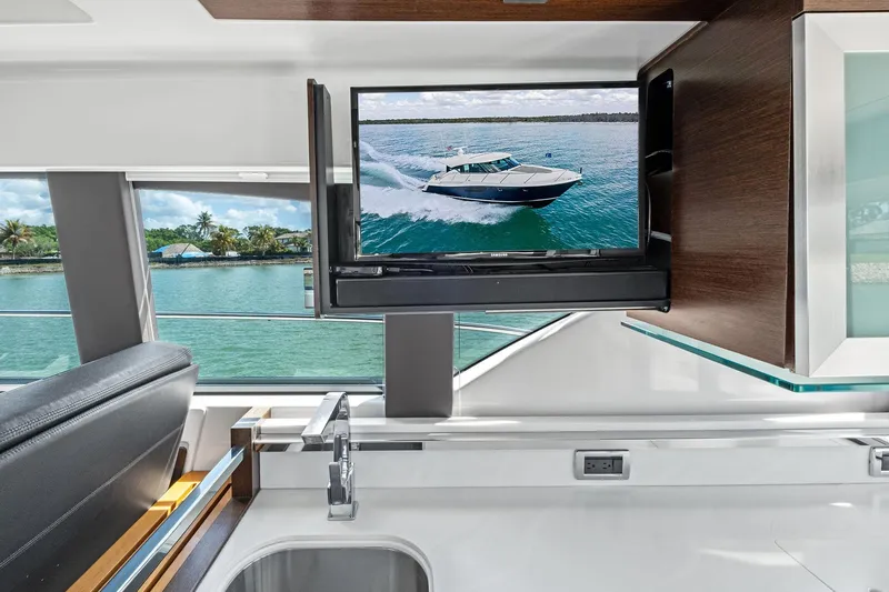 Slide: The Image of Interior of 2018 Tiara Yachts C44 Coupe with TV and scenic water view. - 44