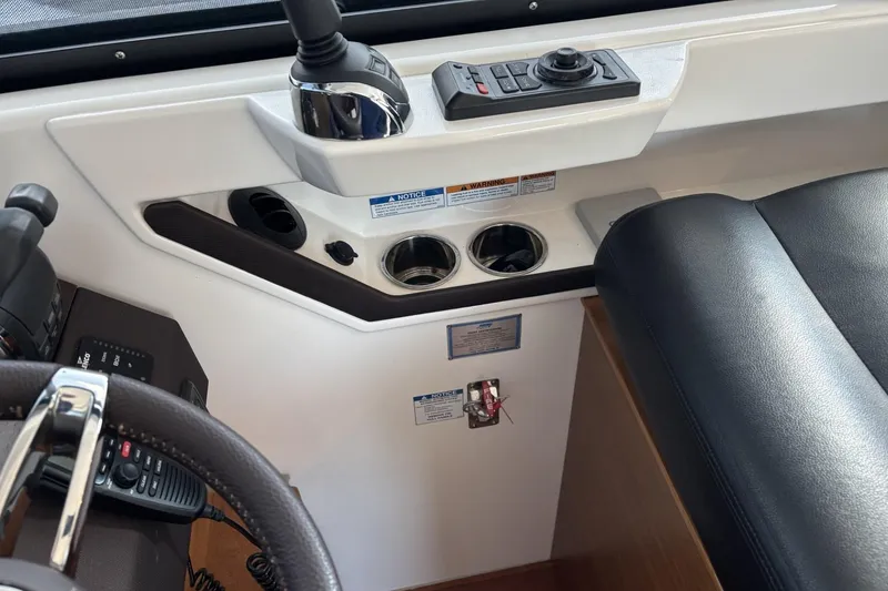 Slide: The Image of 2018 Tiara Yachts C44 Coupe helm with controls and cup holders. - 5