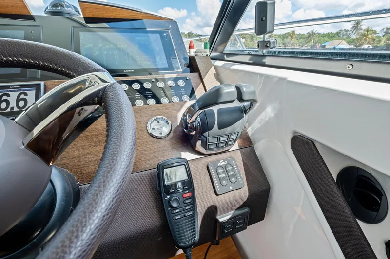 Slide: The Image of 2018 Tiara Yachts C44 Coupe helm with advanced navigation and control systems. - 53