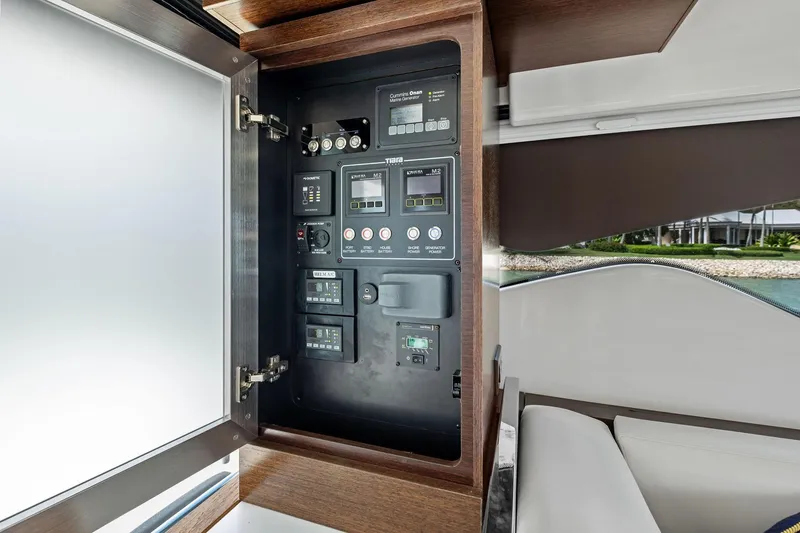 Slide: The Image of Control panel inside 2018 Tiara Yachts C44 Coupe, featuring various switches and displays. - 57