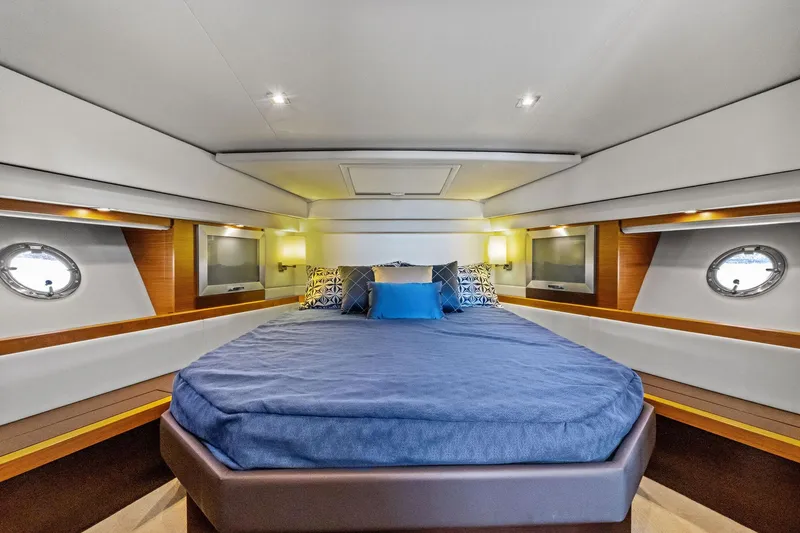 Slide: The Image of Luxurious bedroom interior of 2018 Tiara Yachts C44 Coupe with modern design and porthole windows. - 59