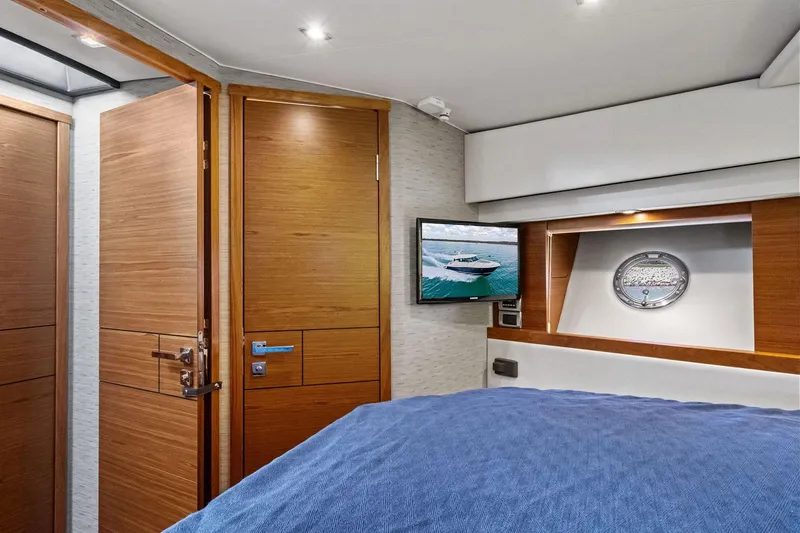 Slide: The Image of Interior of 2018 Tiara Yachts C44 Coupe with wood accents and porthole window. - 60