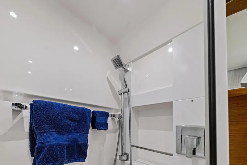 Slide: The Image of 2018 Tiara Yachts C44 Coupe bathroom with shower and blue towels. - 62