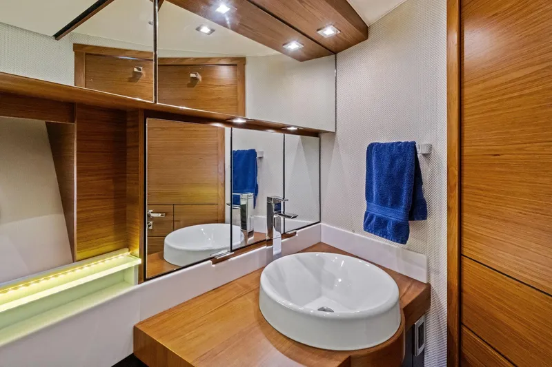 Slide: The Image of Luxurious bathroom in 2018 Tiara Yachts C44 Coupe with modern fixtures and wooden accents. - 64