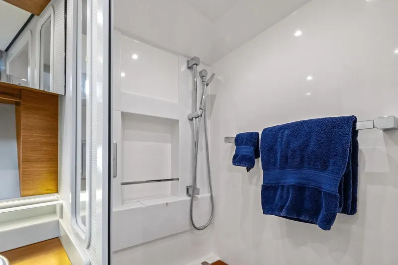 Slide: The Image of Luxurious bathroom in 2018 Tiara Yachts C44 Coupe with modern shower and blue towels. - 66