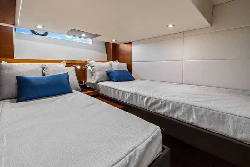 Slide: The Image of 2018 Tiara Yachts C44 Coupe cabin with twin beds and modern decor. - 69