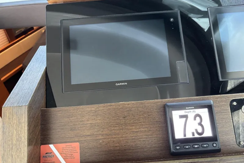 Slide: The Image of Garmin navigation display on 2018 Tiara Yachts C44 Coupe, showing depth of 7.3 feet. - 7