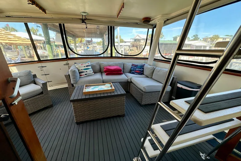 Slide: The Image of 1988 Californian 45 Motor Yacht interior with cozy seating and nautical decor. - 10