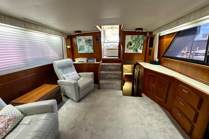 Slide: The Image of Interior of 1988 Californian 45 Motor Yacht with plush seating and wooden cabinetry. - 14