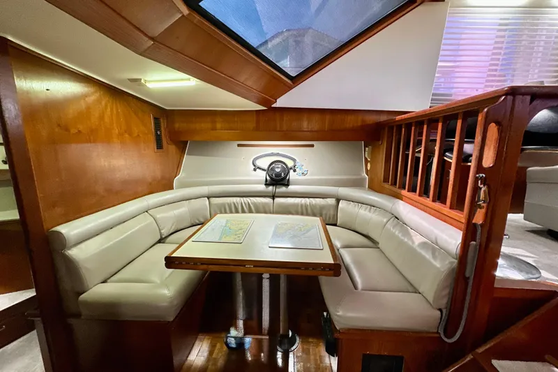Slide: The Image of 1988 Californian 45 Motor Yacht interior with cozy seating and wooden accents. - 17