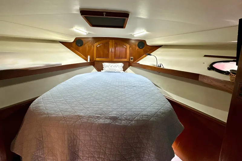 Slide: The Image of Cozy cabin interior of 1988 Californian 45 Motor Yacht with bed and wooden accents. - 18