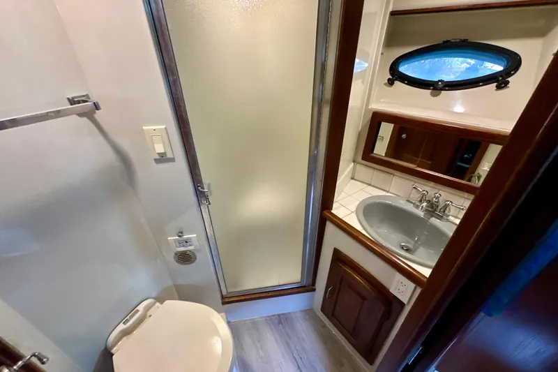 Slide: The Image of 1988 Californian 45 Motor Yacht bathroom with shower, sink, and porthole window. - 19
