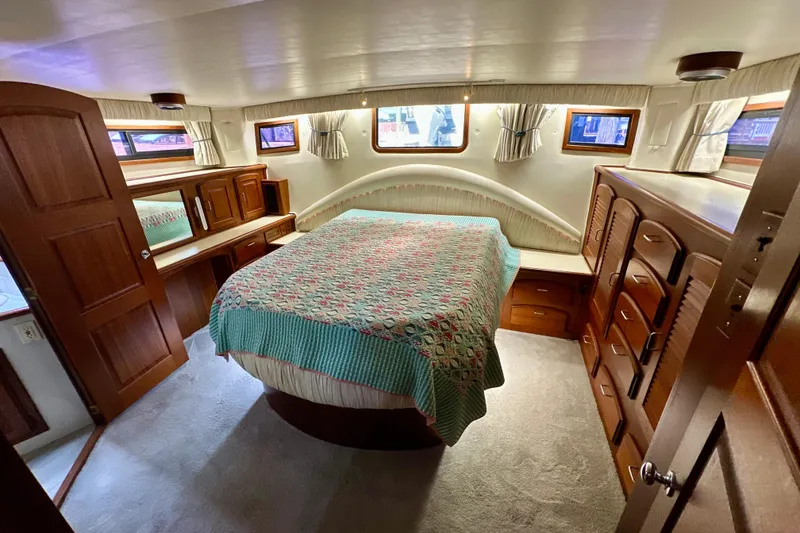 Slide: The Image of 1988 Californian 45 Motor Yacht bedroom with wood furnishings and cozy decor. - 20