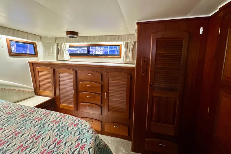 Slide: The Image of Interior of 1988 Californian 45 Motor Yacht with wooden cabinetry and windows. - 21