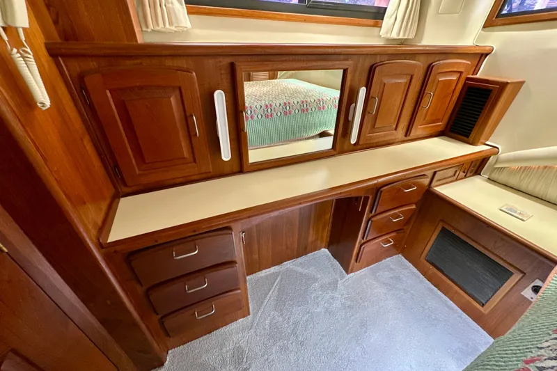 Slide: The Image of 1988 Californian 45 Motor Yacht interior with wooden cabinetry and mirror. - 22