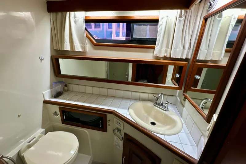 Slide: The Image of Bathroom interior of 1988 Californian 45 Motor Yacht with sink, toilet, and mirror. - 27