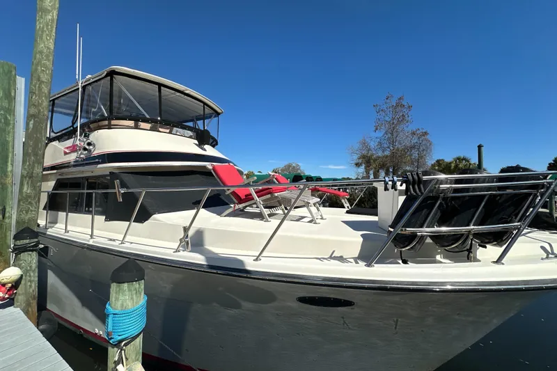 Slide: The Image of 1988 Californian 45 Motor Yacht docked, featuring spacious deck and sleek design. - 3