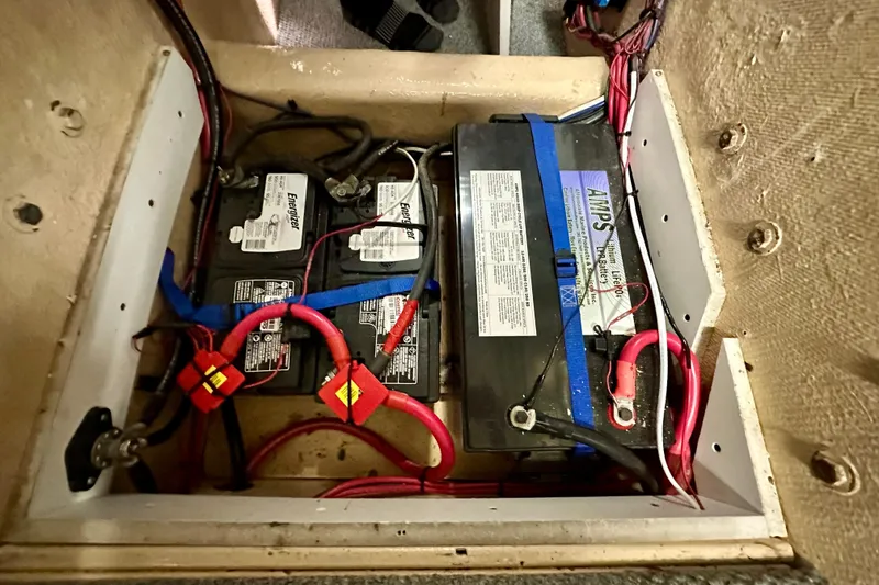 Slide: The Image of Battery compartment of a 1988 Californian 45 Motor Yacht with wiring and connections. - 47