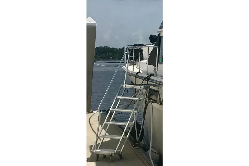 Slide: The Image of 1988 Californian 45 Motor Yacht docked with boarding ladder. - 49