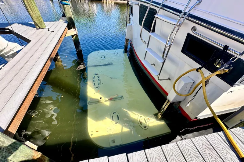 Slide: The Image of 1988 Californian 45 Motor Yacht docked, showing stern and swim platform partially submerged. - 7