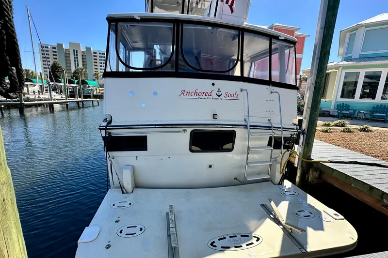 Slide: The Image of 1988 Californian 45 Motor Yacht docked, rear view with "Anchored Souls" text. - 8