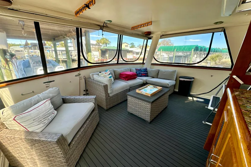 Slide: The Image of Luxurious interior of 1988 Californian 45 Motor Yacht with comfortable seating and panoramic windows. - 9