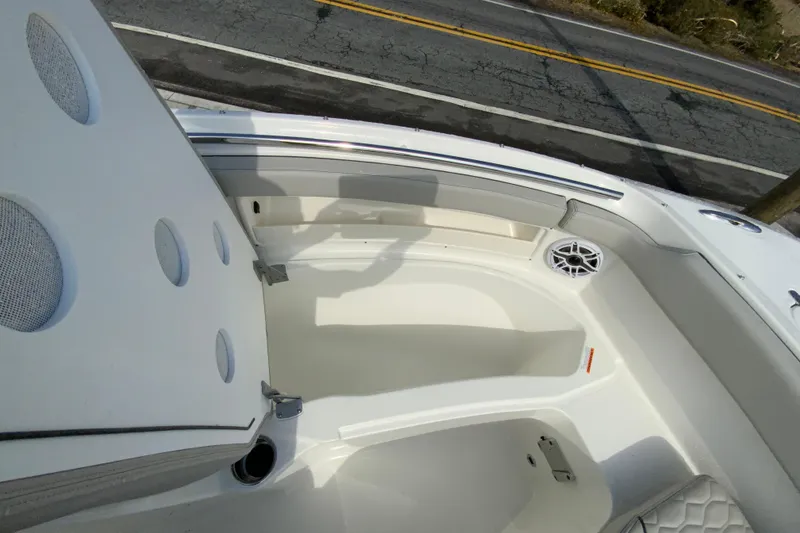Slide: The Image of 2026 Pursuit DC 266 Dual Console boat interior with seating and speaker detail. - 15