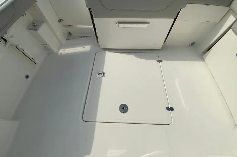 Slide: The Image of 2026 Pursuit DC 266 Dual Console boat interior with storage compartment. - 17