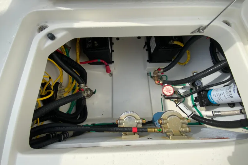 Slide: The Image of 2026 Pursuit DC 266 Dual Console boat engine compartment with wiring and components. - 24