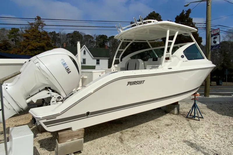 Slide: The Image of 2026 Pursuit DC 266 Dual Console boat with Yamaha engine on display outdoors. - 3